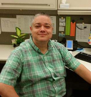 Steve Foster sitting at his desk